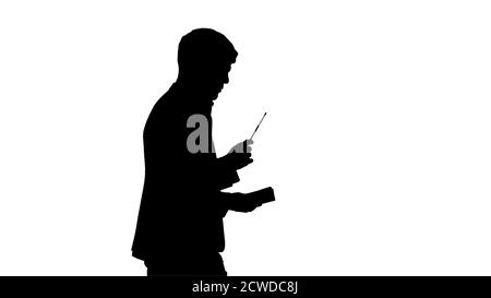 Silhouette Denken Geschäftsmann schriftlich Notizen in seinem Notizbuch wh Stockfoto