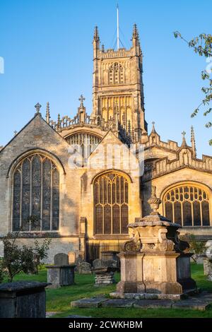 Die Kirche des heiligen Johannes des Täufers aus dem Garten der Erinnerung bei Sonnenaufgang im Herbst. Cirencester, Cotswolds, Gloucestershire, England Stockfoto