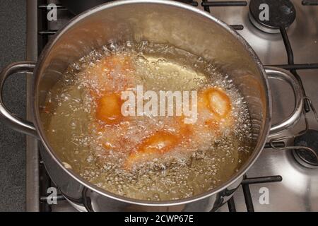 Hausgemachtes Bier zerschlagen Schellfisch Frittieren in einer Pfanne Heißes Öl Stockfoto