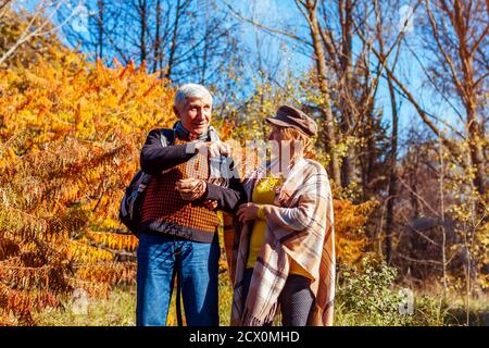 Herbstaktivitäten. Ältere Familie Paar zu Fuß im Herbst Park. Mann und Frau genießen die Natur im Freien reden bewundernde Aussicht Stockfoto