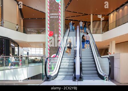 Sevilla, Spanien - 18. September 2020: Menschen an der automatischen Treppe des Lagoh Shopping Centers tragen Schutzmaske wegen Coronavirus covid-19. Neue Norm Stockfoto
