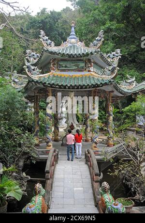 Touristen in einer kleineren Pagode am Xa Loi Tempel, Marble Mountains, in der Nähe von Danang, Vietnam Stockfoto