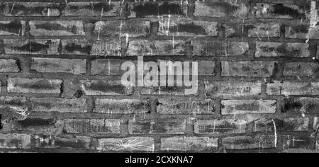 Abstrakt schwarz alten zerkratzten Backstein Wand Hintergrund. Schöne dunkle Wandoberfläche Stockfoto