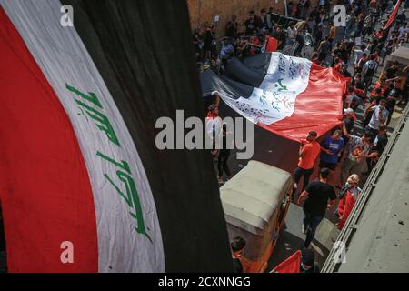 Bagdad, Irak. Oktober 2020. Irakische Demonstranten halten während eines Protestes eine nationale Flagge, um den ersten Jahrestag der Anti-Regierung-Demonstrationen zu begehen. Quelle: Ameer Al Mohammedaw/dpa/Alamy Live News Stockfoto