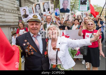 Der Londoner Marsch des Immortal Regiments, der marsch soll russischen Männern und Frauen gedenken, die im Zweiten Weltkrieg gekämpft haben und in Russland und anderen Ländern am 9. Mai im Rahmen der Feierlichkeiten zum Victory Day stattfinden. Während der Märsche tragen die Menschen Fotos ihrer Verwandten, die am Krieg teilnahmen. Etwa 12 Millionen Menschen nahmen 2015 an den Märschen des Immortal Regiments in ganz Russland Teil. Der Londoner marsch begann von der Nordterrasse des Trafalgar Square, direkt vor der National Gallery, dem 'Regiment', dann zu Fuß zum College Green über Whitehall, Downing Street, Parliament Square und West Stockfoto