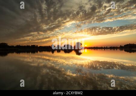 Sonnenuntergang und Spiegelung von Wolken im Wasser Stockfoto