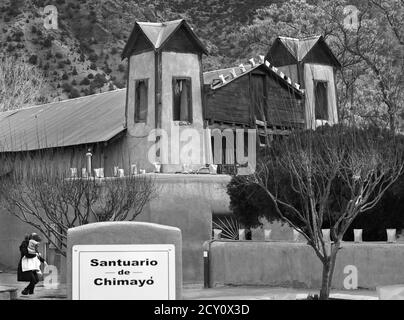 Touristen und Gläubige besuchen den historischen Santuario de Chimayo, der 1816 von adobe in dem kleinen hispanischen Dorf Chimayo, New Mexico, USA gebaut wurde. Stockfoto