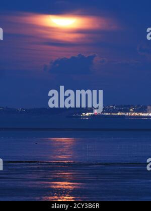 Shellness, Kent, Großbritannien. Oktober 2020. UK Wetter: Der atemberaubende, volle Erntemond, der heute Abend aus Shellness in Kent über Herne Bay aufsteigt. Kredit: James Bell/Alamy Live Nachrichten Stockfoto