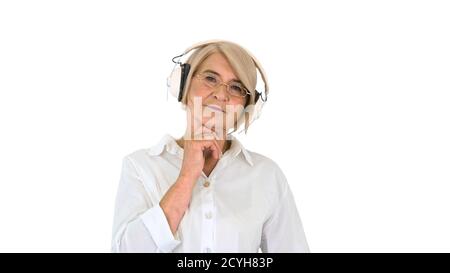 Alte intelligente Frau, die Musik in Kopfhörern auf Weiß hört Stockfoto