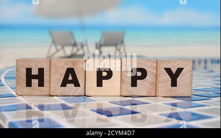Happy Word Holzwürfel auf einem Ozean Hintergrund. Lifestyle-Konzept Stockfoto