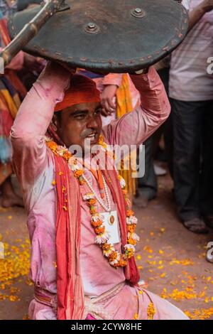 Barsana, Indien - 24. Februar 2018 - Lathmar Holi Festival - Frauen schlagen Männer mit Bambusstäben, bis man aufgibt Stockfoto