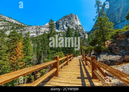 Panorama von Half Dome und Liberty Cap Gipfel von Nevada fallen Wasserfall auf Merced River Brücke von Mist Trail im Yosemite National Park. Reise im Sommer in Stockfoto