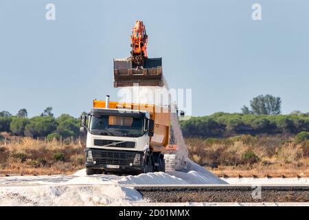 Huelva, Spanien - 1. Oktober 2020: Bagger lädt Salz in einen LKW im Naturschutzgebiet Marismas del Odiel. Traditionelle Meersalzproduktion ist Salz, das Stockfoto