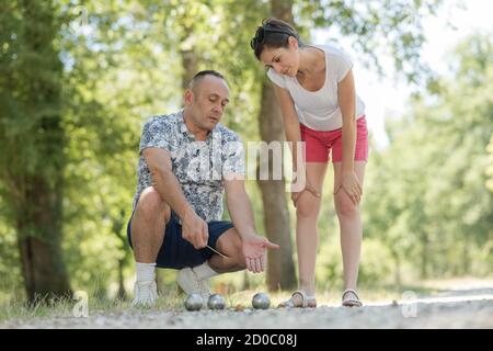 Glückliche Familie von zwei Generationen spielen Boccia in einem Garten Stockfoto