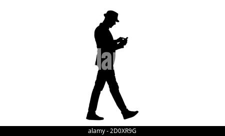 Silhouette ernsthafte arabisch casual Mann mit Smartphone beim Gehen. Stockfoto