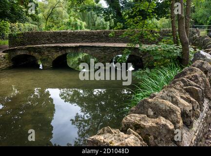 Eine Fußgängerbrücke über den Fluss in Castle Combe, Wiltshire, Großbritannien Stockfoto