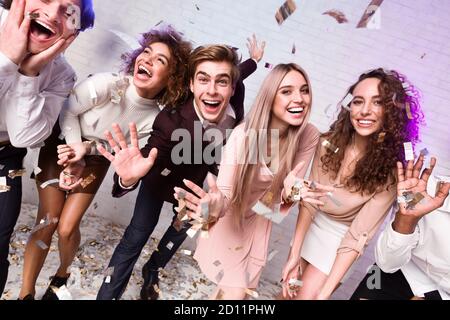 Millennial Freunde Genießen Neujahrsfeier Unter Fallenden Konfetti Innen Stockfoto