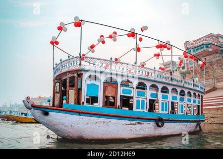 18.12.2019, Varanasi, Indien. Indische mehrfarbige Kerala Boot mit aufblasbaren Kugeln, im Hafen festgemacht. Stockfoto