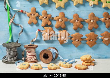 Herstellung von Lebkuchenkette für Weihnachten auf Holztisch Stockfoto
