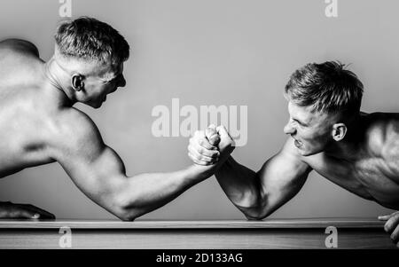 Armdrücken. Zwei Männer Armringen. Rivalität, Nahaufnahme von männlichen Armringen. Zwei Hände. Schwarz und Weiß. Männer messen Kräfte, Waffen. Handringen Stockfoto