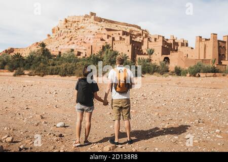 Ein paar Rucksacktouristen im Hintergrund Ait Ben Haddou ksar in Ouarzazate. Willkommen in Marokko. Reisekonzept. Beliebtes Wahrzeichen. Stockfoto