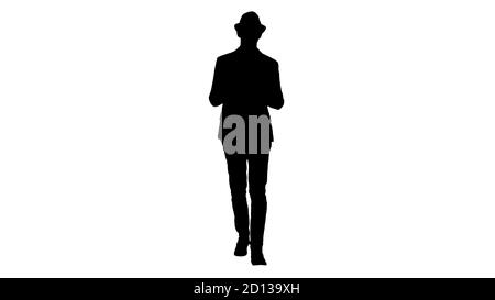 Silhouette Gelegenheitlicher Mann in einem Hut zu Fuß und zeigt digitale Tablette zur Kamera. Stockfoto