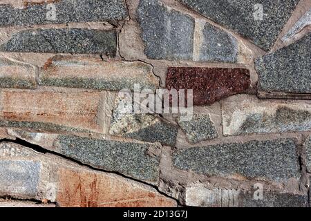 Hintergrund aus Marmor und Granitsteinen in Mauerwerk ausgelegt Stockfoto