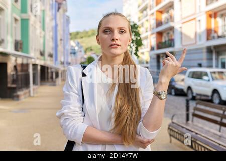 Außenportrait der sprechenden jungen Geschäftsfrau in der Stadt Stockfoto