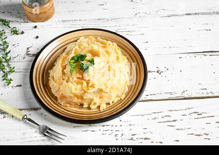 Leckere Pastinaken mit Kartoffeln und Karotten auf weißem Holzhintergrund. Leckeres und gesundes vegetarisches Püree, reich an Vitaminen und Mineralstoffen. Stockfoto