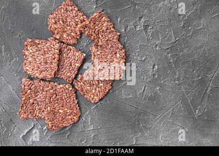 Knusprige Mehrkorngetreide Leinsamen-Knäckebrot. Quadratische Riegel für gesunde Snacks. Energie-Riegel ohne Zuckerzusatz. Draufsicht Stockfoto