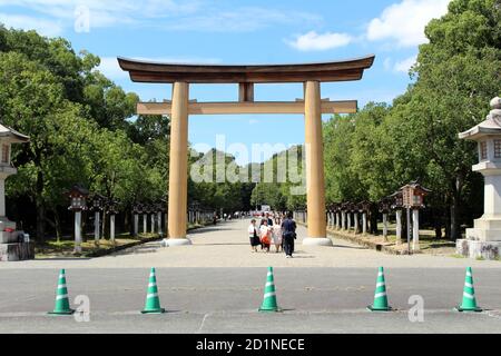 Japanische Familie, die vor dem Eingang torii Tor des Kashihara Jingu Temple fotografiert. Aufgenommen im September 2019. Stockfoto