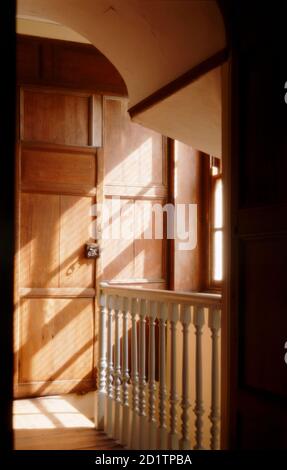 GREAT YARMOUTH REIHENHÄUSER, NORFOLK. Innenansicht des Hauses des alten Händlers. Die Treppe im ersten Stock nach Osten mit Sonnenlicht durch das Fenster. Die Treppe wurde im 18. Jahrhundert eingeführt. Zuvor waren die oberen Stockwerke über eine Treppe neben dem zentralen Schornsteinstapel erreicht. Stockfoto