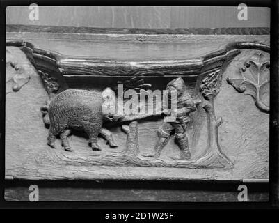 Ein Misericord in St. Mary's Church, zeigt einen Ritter mit einem Speer, der ein Wildschwein angreift, North Bar Within, Beverley, East Riding of Yorkshire, Großbritannien. Stockfoto