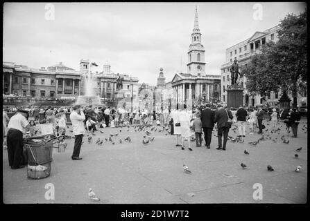 Trafalgar Square, St James, Westminster, City of Westminster, Greater London UK mit National Gallery, St Martin in the Fields und Straßenverkäufern. Stockfoto