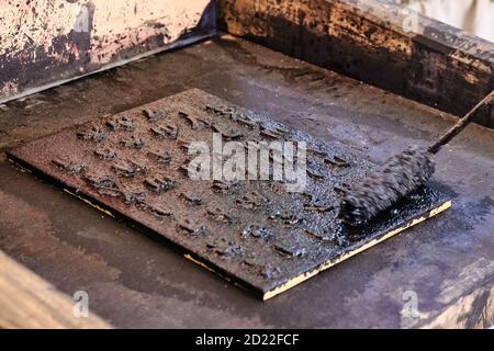 Die Anwendung von Tinte auf einer Vintage-Druckmaschine. Retro Print Bücher in Kyrillisch. Stockfoto