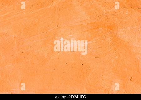 Orangefarbener strukturierter abstrakter Hintergrund auf Papier. Stockfoto