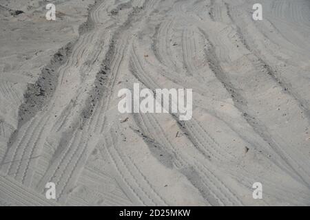 Autoreifen Tracks Auf Dem Strand Sand In Perspektive. Autoreifen druckt auf EINER Straße, die zum sandbedeckten Strand führt. Radspuren Auf Dem Boden. Radspur Ein Stockfoto