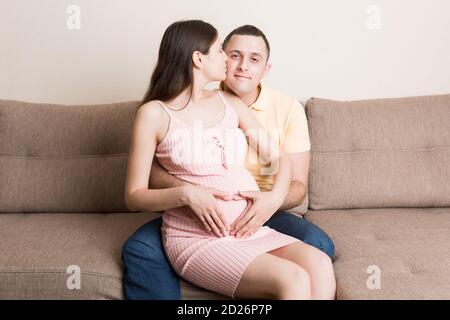 Schwangerschaft, Erwartung eines Kindes. Zukünftige Eltern mit Händen in Form von Herz. Der Mann legte seine Hand auf den Bauch der Frau. Stockfoto