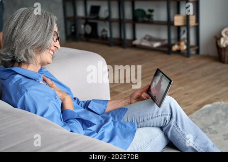 Glücklich ältere alte Großmutter Video ruft Enkelin auf Weihnachten. Stockfoto
