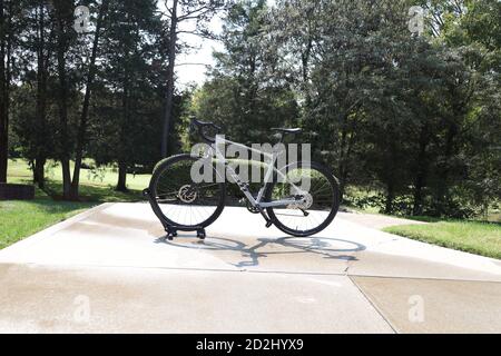 Ein Schotterfahrrad auf einem Stand nach einer frischen Wäsche An einem sonnigen Tag mit Haus im Hintergrund Stockfoto