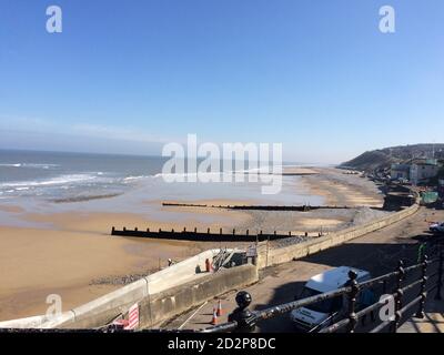 Cromer Sandstrand an einem sonnigen Tag mit ruhigem Meer an einem Nordseestrand in England, Norfolk, Großbritannien, Seestrand Stockfoto