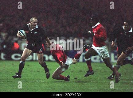 WALES V NEW ZEALAND, WEMBLEY 29-11-97 All Blacks Christian Cullen wird von Allen Bateman während des heutigen (Samstag) Rugby Union Clash mit Wales in Wembley in Angriff genommen. Foto von Neil Munns/PA Stockfoto