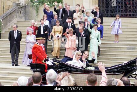 Prinz Edward und seine Braut Sophie Rhys-Jones winken aus einer offenen Kutsche zu den Wohltätern, als sie nach ihrer Hochzeit die St. George's Chapel in Windsor verlassen. Die Familien des glücklichen Paares winken sie von den Stufen der Kapelle ab. Stockfoto