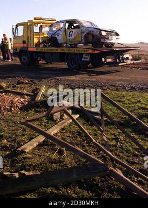 Ein Rallyewagen Vauxhall Nova wird abgeschleppt, nachdem eine Person getötet wurde und mindestens fünf weitere, darunter ein Kind, ins Krankenhaus gebracht wurden, nachdem er bei einer Kundgebung auf dem Bennets-Feld in der Nähe des Heereslagers in Otterburn, Northumberland, mit Zuschauern zusammengestoßen war. * Zuschauer beobachteten die Kundgebung, als der Unfall kurz vor 10.30 Uhr geschah. Bild zeigt den Abschnitt des Zauns, durch den es im Vordergrund abgestürzt ist. Stockfoto