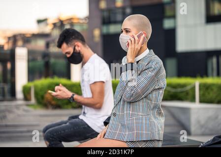 Frau benutzt ihr Handy während der covid-19 Pandemie, Konzepte über soziale Distanzierung, Technolgie und Corona-Virus. Stockfoto