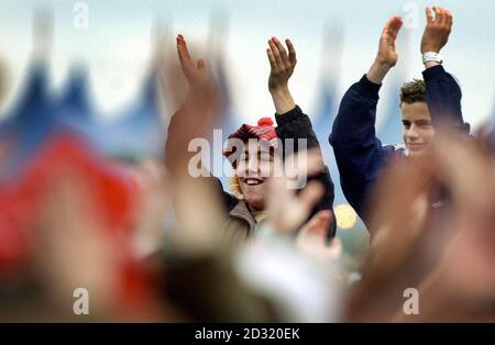Ein Fan erhebt sich über die Menge, um den Streichern beim T in the Park Musikfestival in der Nähe von Kinross, Schottland, zuzuhören. Stockfoto