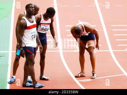 Das GB 4x100 Staffelteam (von l-r), Dwain Chambers, Marlon Devonish und Christian Malcolm schauen auf, als Teamkollege Darren Campbell (ganz rechts) sein verletztes Bein nach dem zweiten Platz hinter dem US-Team im 4x100-Staffelfinale der Männer bei den Leichtathletik-Weltmeisterschaften in Paris einschließt. Stockfoto