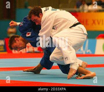 Englands Craig Fallon (Blau) im Einsatz gegen Schottlands John Buchannan, in Commonwealth Games Männer 60 kg Judo, im G-Mex Center in Manchester. Stockfoto