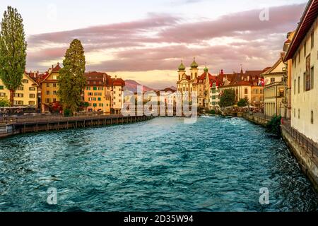 Sonnenuntergang in der Innenstadt von Luzern am Fluss Luzern in der Zentralschweiz. Jesuitenkirche oder Jesuitenkirche St. Franz Xaver am Reuss Stockfoto