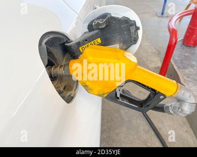 Kleines weißes Auto tanken an der Tankstelle. Autotanken an der Tankstelle Stockfoto